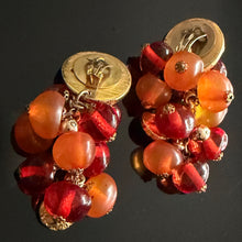 Load image into Gallery viewer, Rare and beautiful vintage clip-on earrings by Jacky de G, featuring Medusa head motifs and orange pendant beads