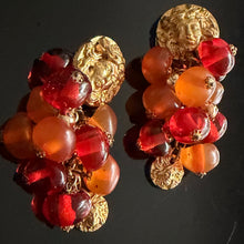 Load image into Gallery viewer, Rare and beautiful vintage clip-on earrings by Jacky de G, featuring Medusa head motifs and orange pendant beads