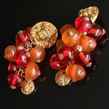 Load image into Gallery viewer, Rare and beautiful vintage clip-on earrings by Jacky de G, featuring Medusa head motifs and orange pendant beads
